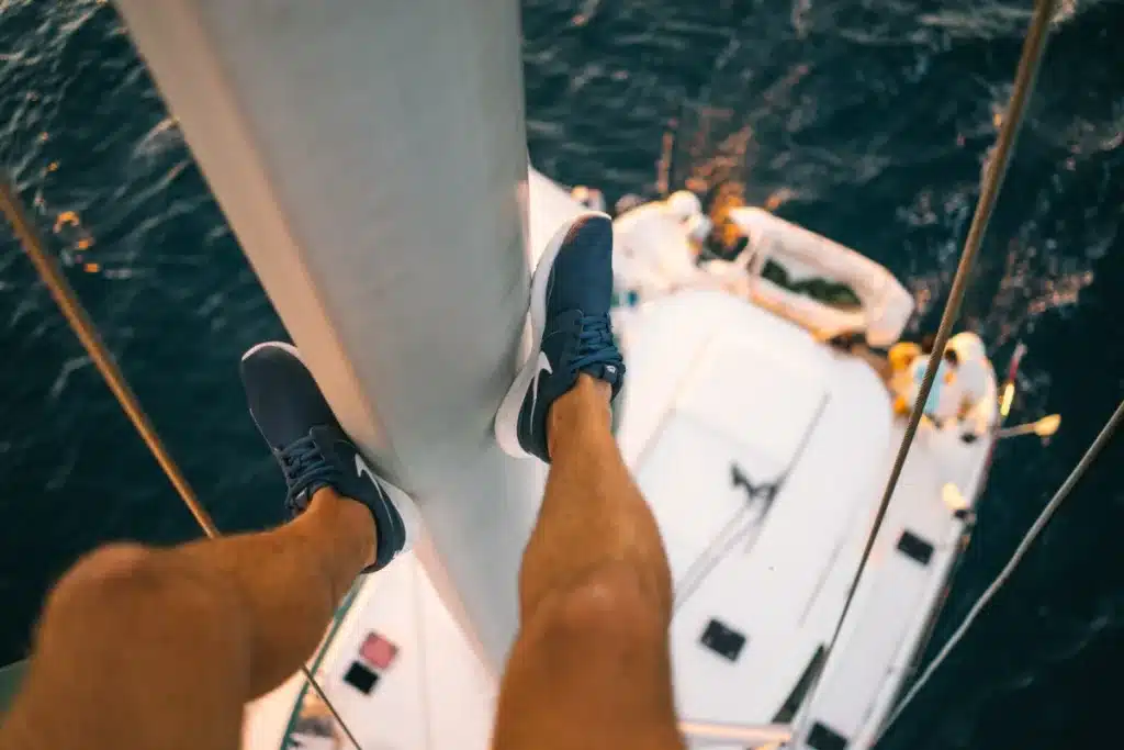 A captain in the mast — the working side of a charter.